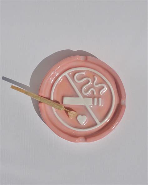 Ceramic ashtray hand-embossed with the no smoking sign in pink and white. This quirky ashtray is ...