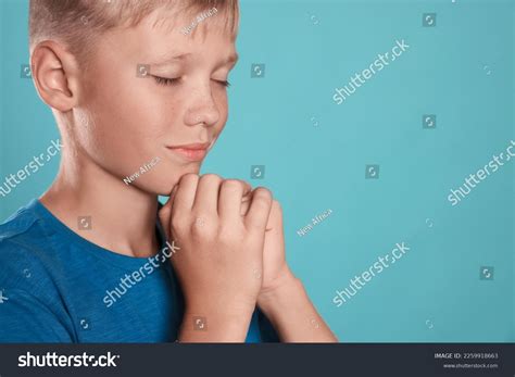 Boy Clasped Hands Praying On Turquoise Stock Photo 2259918663 ...