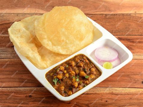 Premium Photo | Chole Bhature spicy Chick Peas curry also known as Chole or Channa Masala is ...