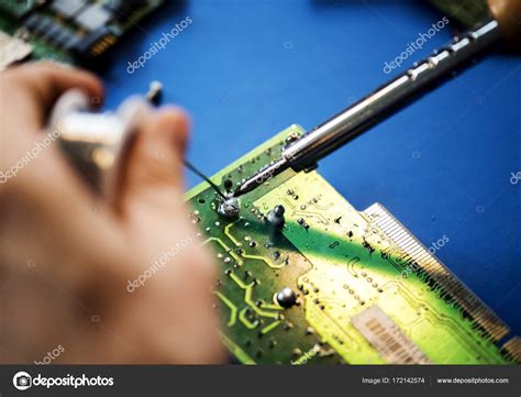 Hands soldering tin to electronics circuit board Stock Photo by ©Rawpixel 172142574