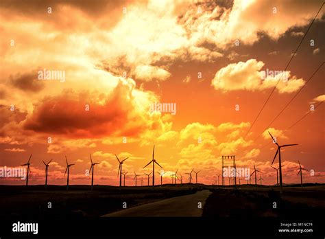 Wind turbine field at sunset, dramatic sky Stock Photo - Alamy