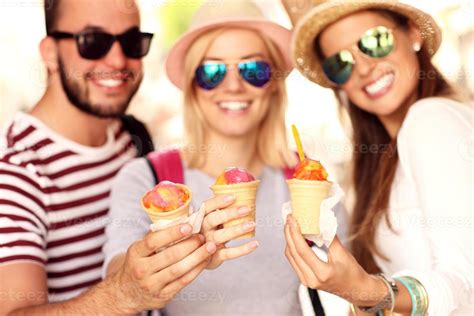 Group of friends eating ice-cream 15813996 Stock Photo at Vecteezy