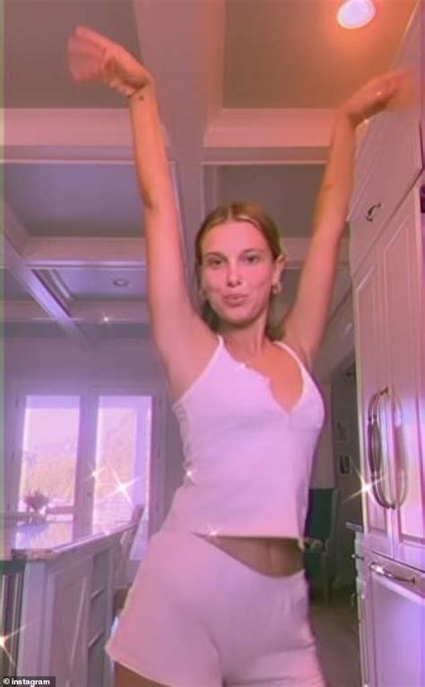 Millie Bobby Brown dances around in a pink pyjama set in fun clip as she promotes her florence ...