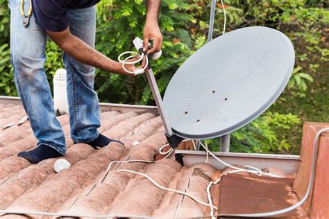 Worker Installing Satellite Dish and Antenna on Roof Top Stock Photo ...