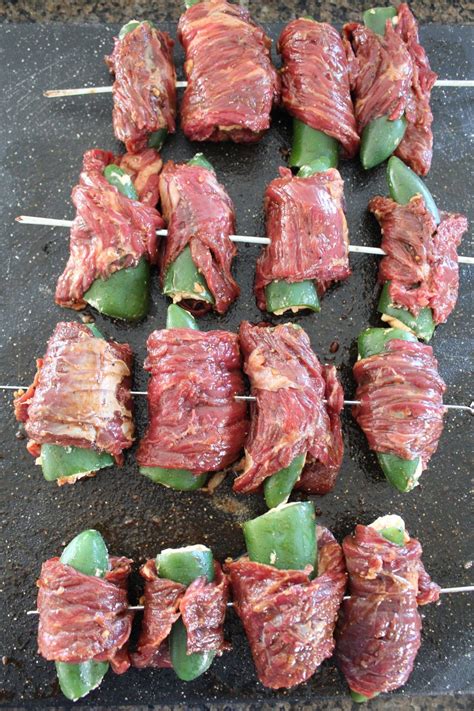 several skewers of meat and vegetables on a grill