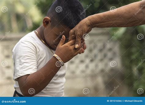 A Respectful Boy Does the Mano Po Gesture To His Grandmother. a Sign of ...