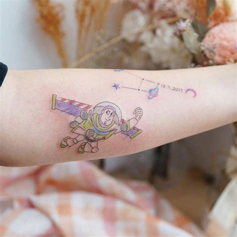 Buzz Lightyear tattoo on the inner forearm.