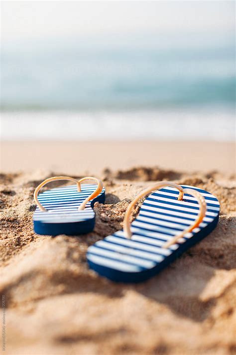 "Marine Flip-flops On The Beach. Summertime." by Stocksy Contributor "BONNINSTUDIO " - Stocksy