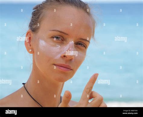 Putting on sun tan cream hi-res stock photography and images - Alamy