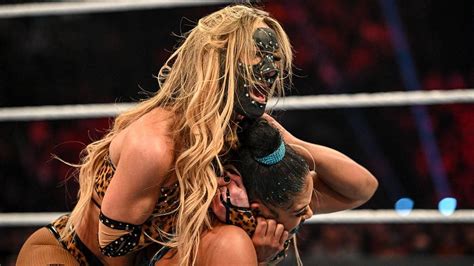 Why does WWE RAW Superstar Carmella wear a mask?