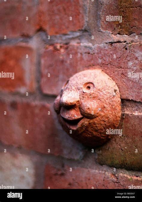 brick face on wall of house smile smiling Stock Photo - Alamy