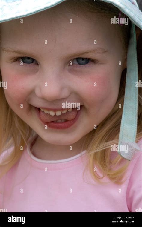 Young girl with a cheeky smile Stock Photo - Alamy