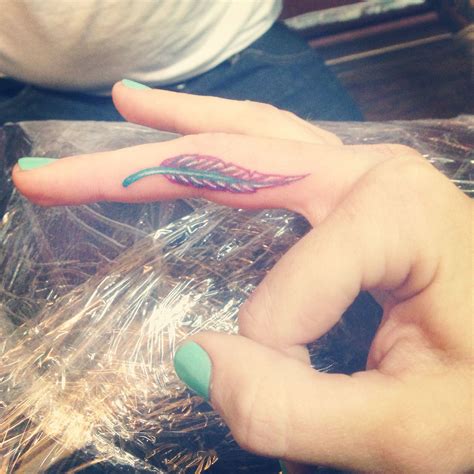 Pin by Ashley Senoski on Tattoos | Feather tattoos, Finger tattoo for women, Finger tattoos