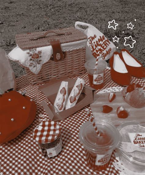 picnic items are laid out on a checkered tablecloth with red and white decorations