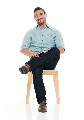 Charming Man Seated And Smiling Stock Photo - Download Image Now - iStock