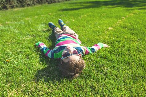 The Boy is Lying on the Grass. Stock Photo - Image of people, leisure: 130354100