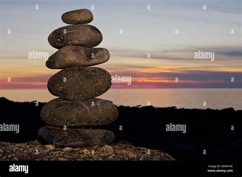 Stone formation along the beach at Delaps Cove during sunset over the ...