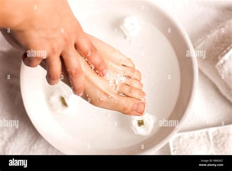 Female feet with sea salt soaked in a bowl of water on white background Stock Photo - Alamy