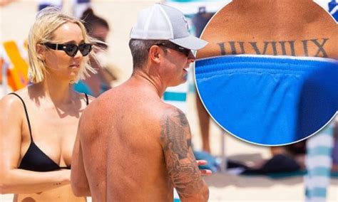 Michael Clarke shows off his rarely-seen tramp stamp tattoo and full ...