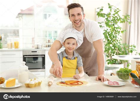 Dad and son cooking at home — Stock Photo © belchonock #148839061