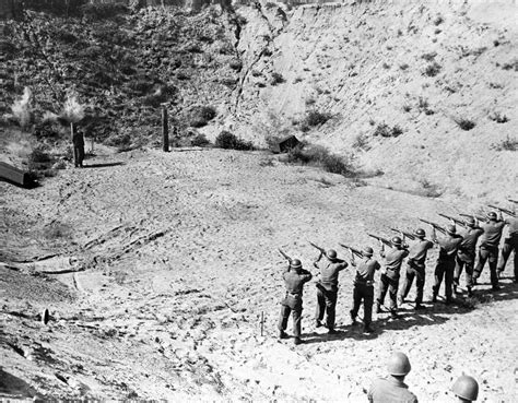 A firing squad of the U.S. Ninth Army executes 16 year old Heinz Petry of the Hitler Jugend for ...