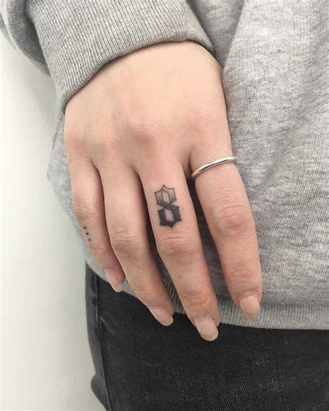 Number 8 tattoo by Gianina Caputo inked on the right hand’s middle ...