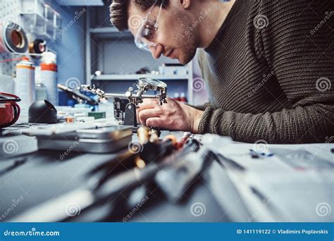 Electronic Technician Working in the Repair Shop Stock Photo - Image of gloves, device: 141119122