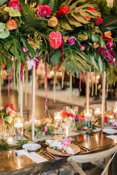 Tropical garden wedding centerpiece with palm leaves & fronds. Wood farm table… | Garden wedding ...