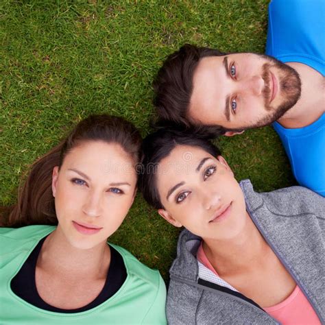So Much Potential. High Angle Shot of a Three Friends Lying Down on Grass. Stock Image - Image ...