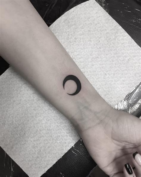 Black moon tattoo on the wrist - Tattoogrid.net