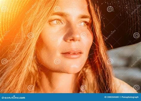 Portrait of Happy Young Woman Wearing Summer Black Hat with Large Brim at Beach on Sunset ...