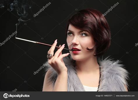 Woman with cigarette holder | Woman smoking with cigarette holder — Stock Photo © belchonock ...