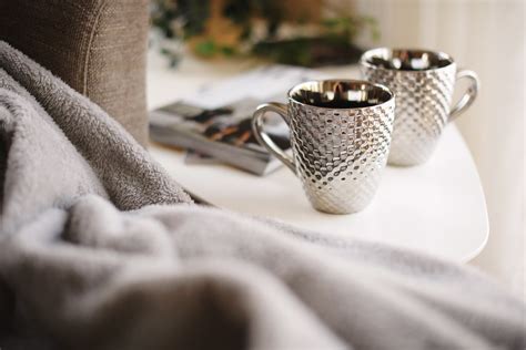 two silver mugs on white side table - Credit to https://my… | Flickr