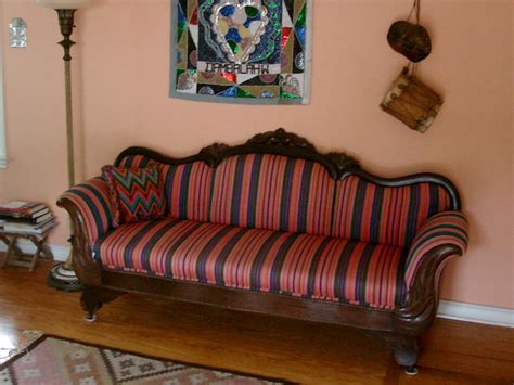 This antique, Victorian-style couch has been re-upholstered with ...