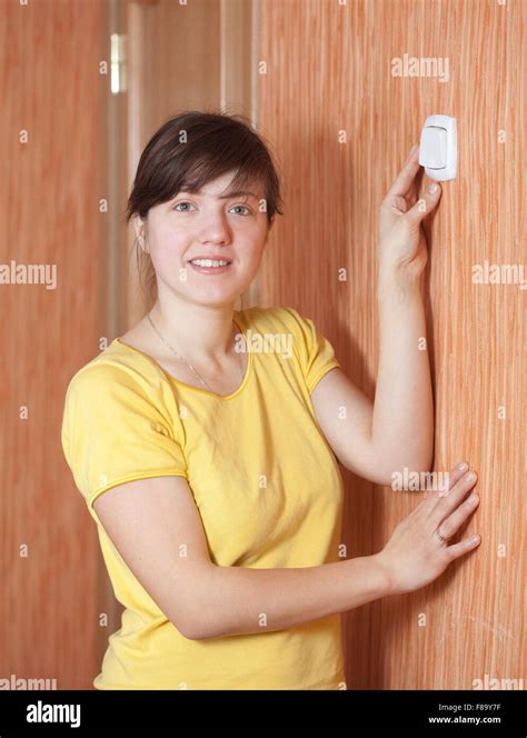 Young woman turning off the light-switch in home Stock Photo - Alamy