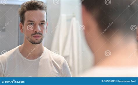 Confident Young Man Looking at Mirror Stock Image - Image of laughing, satisfaction: 187454829