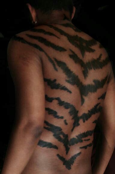 Tiger stripes | Tiger stripe tattoo, Stripe tattoo, Tattoos for guys