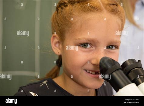 Close-up of a School girl smiling with microscope, Fürstenfeldbruck, Bavaria, Germany Stock ...