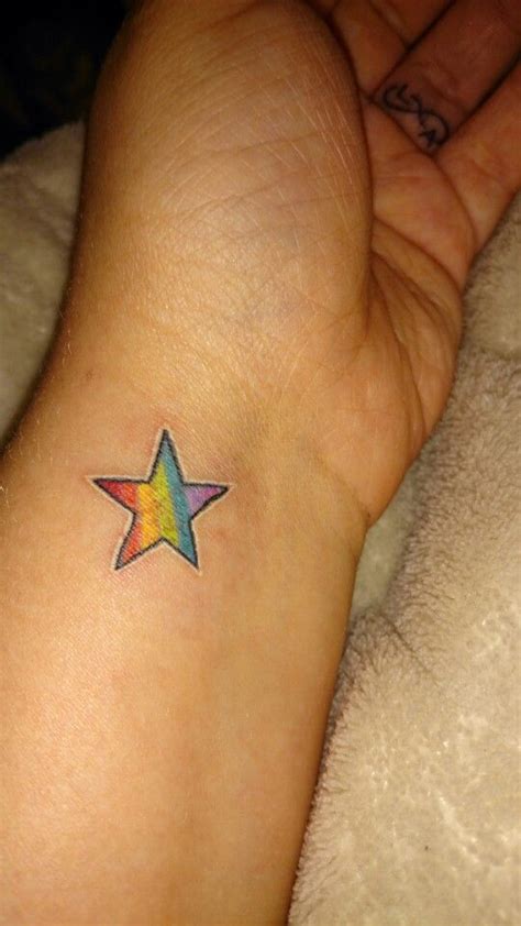 Rainbow star wrist tattoo | Rainbow tattoos, Rose tattoos for women ...