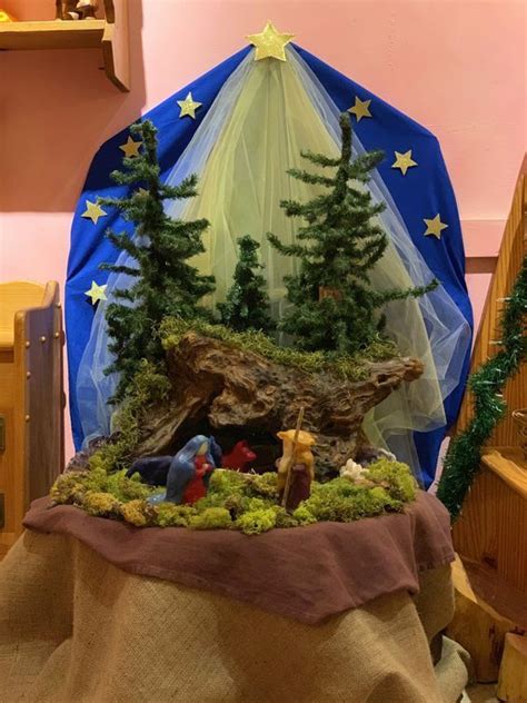 a nativity scene is set up in the corner of a room with other decorations