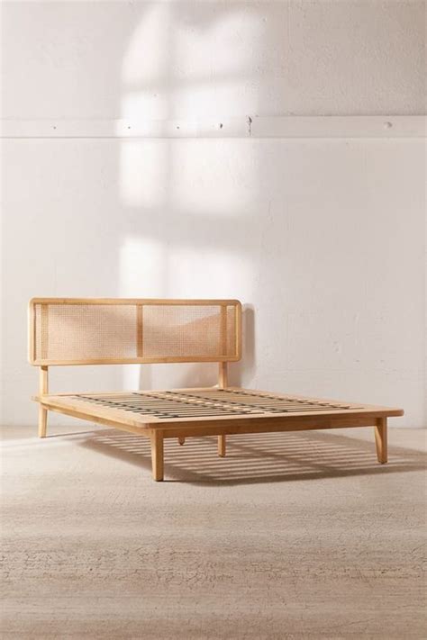 a wooden bed frame sitting on top of a white floor