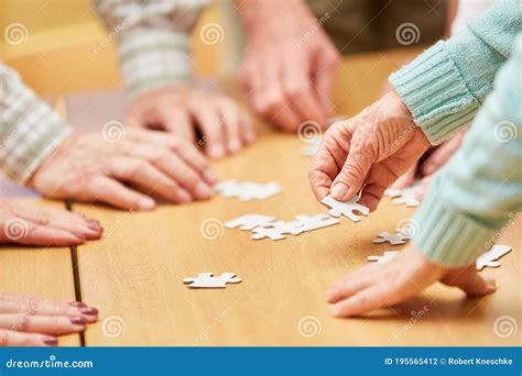 Hand of a Senior Citizen Holds a Piece of the Puzzle Stock Photo - Image of group, eldercare ...