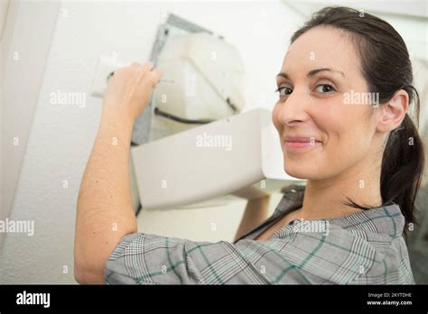 female worker fixing electrical issue with hand dryer Stock Photo - Alamy