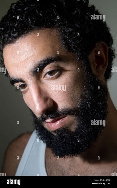 Close up portrait of a young Middle Eastern man with long beard Stock Photo - Alamy