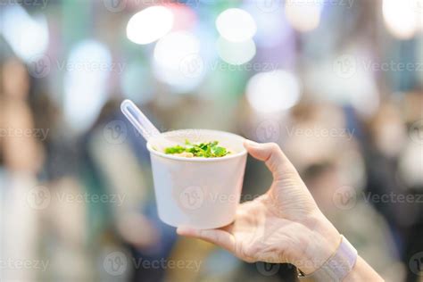 woman hand holding Rice Noodle in paper bowl at Ximending night market ...