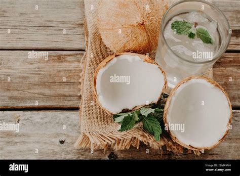 Coconut water. Fresh and delicious coconut water. wood and green ...