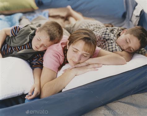 A mother and her two young sons resting in camping tent on beach Stock ...