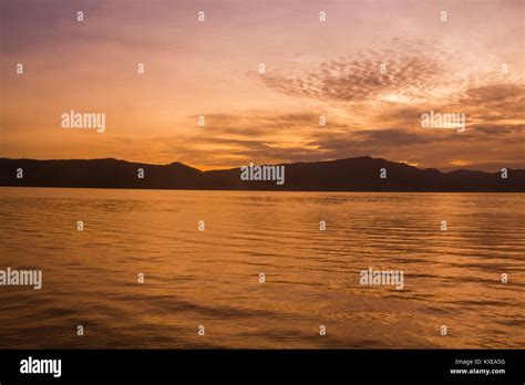 Sunset Sunrise with reflections at Lake Toba, Samosir Island, Indonesia ...