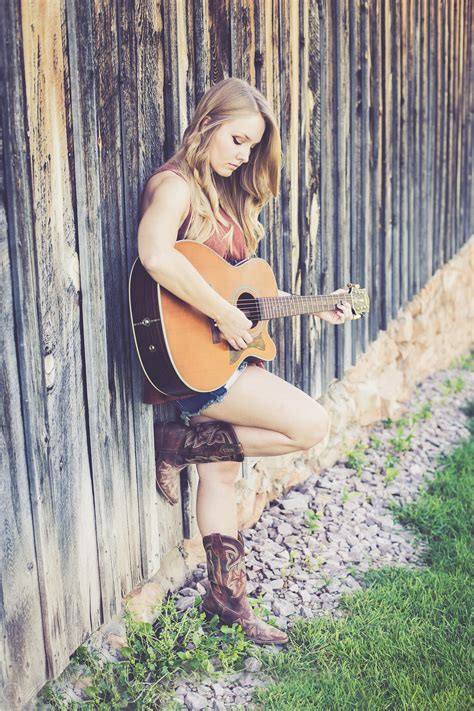 Woman Playing Guitar While Leaning on Wood during Daytime · Free Stock ...