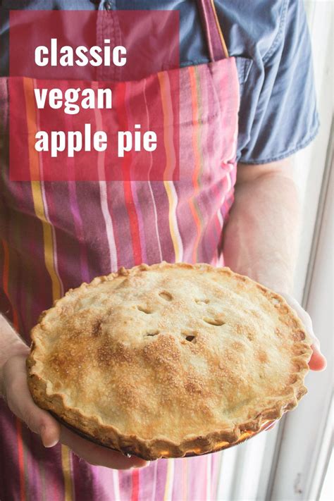 a close up of a person holding a pie in their hand with the words classic vegan apple pie on it